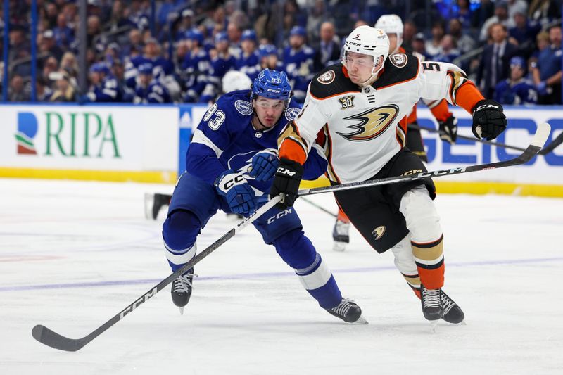 Jan 13, 2024; Tampa, Florida, USA;  Tampa Bay Lightning center Gage Goncalves (93) and Anaheim Ducks defenseman Urho Vaakanainen (5) battle for the puck in the third period at Amalie Arena. Mandatory Credit: Nathan Ray Seebeck-USA TODAY Sports