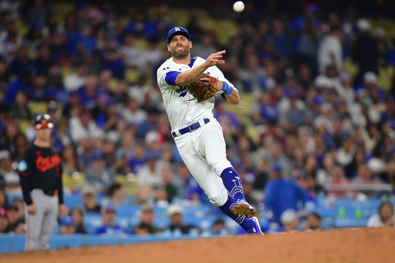 Aug 29, 2024; Los Angeles, California, USA; Los Angeles Dodgers third baseman Chris Taylor (3) throws to first for the out against Baltimore Orioles designated hitter Eloy Jimenez (72) during the eighth inning at Dodger Stadium. Mandatory Credit: Gary A. Vasquez-USA TODAY Sports