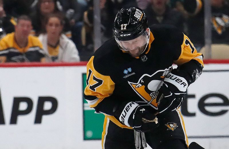 Feb 25, 2024; Pittsburgh, Pennsylvania, USA;  Pittsburgh Penguins right wing Bryan Rust (17) acts after suffering an apparent injury against the Philadelphia Flyers during the third period at PPG Paints Arena.Rust would leave the game. Pittsburgh won 7-6. Mandatory Credit: Charles LeClaire-USA TODAY Sports