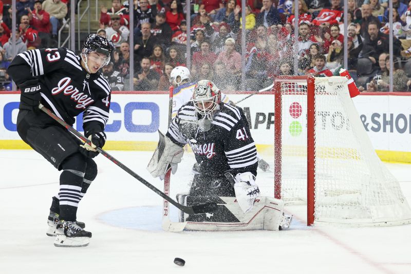 Oct 27, 2023; Newark, New Jersey, USA; New Jersey Devils goaltender Vitek Vanecek (41) looks up after making a save against Buffalo Sabres right wing Alex Tuch (89) during the second period in front of defenseman Luke Hughes (43) at Prudential Center. Mandatory Credit: Vincent Carchietta-USA TODAY Sports