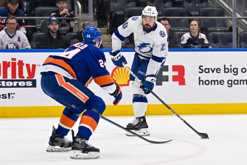 Feb 8, 2024; Elmont, New York, USA; Tampa Bay Lightning left wing Nicholas Paul (20) attempted a short defended by New York Islanders defenseman Scott Mayfield (24) during the first period at UBS Arena. Mandatory Credit: Dennis Schneidler-USA TODAY Sports