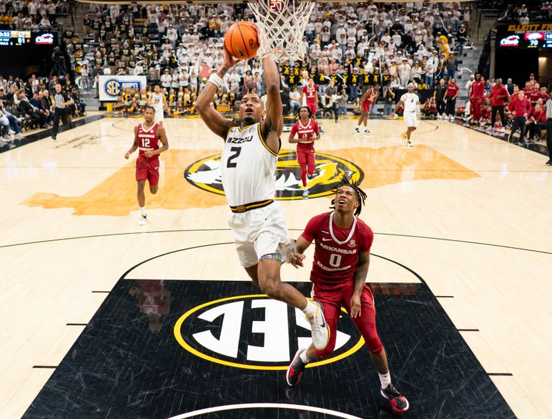 Jan 31, 2024; Columbia, Missouri, USA; Missouri Tigers guard Tamar Bates (2) goes up for a shot against Arkansas Razorbacks guard Khalif Battle (0) during the second half at Mizzou Arena. Mandatory Credit: Jay Biggerstaff-USA TODAY Sports