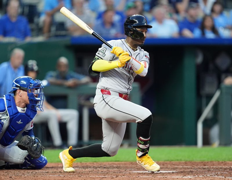 Jul 23, 2024; Kansas City, Missouri, USA; Arizona Diamondbacks shortstop Geraldo Perdomo (2) hits a double against the Kansas City Royals during the fifth inning at Kauffman Stadium. Mandatory Credit: Jay Biggerstaff-USA TODAY Sports