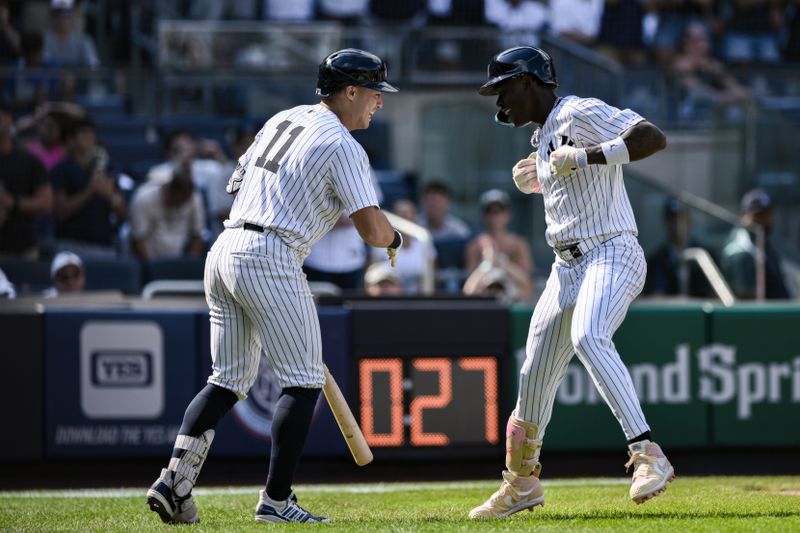 Aug 10, 2024; Bronx, New York, USA; New York Yankees third baseman Jazz Chisholm Jr. (13) celebrates with New York Yankees shortstop Anthony Volpe (11) after hitting a solo home run in the ninth inning against the Texas Rangers at Yankee Stadium. Mandatory Credit: John Jones-USA TODAY Sports