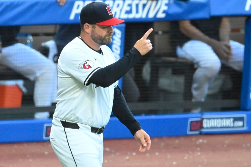 Aug 14, 2024; Cleveland, Ohio, USA; Cleveland Guardians manager Stephen Vogt (12) makes a call to the bullpen in the fourth inning against the Chicago Cubs at Progressive Field. Mandatory Credit: David Richard-USA TODAY Sports