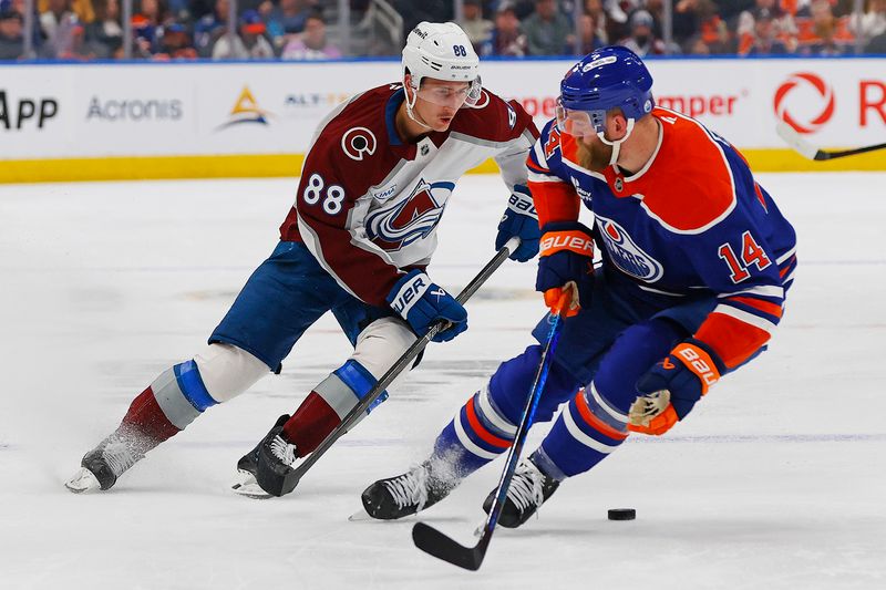 Nov 8, 2025; Edmonton, Alberta, CAN; Colorado Avalanche forward Martin Necas (88) tries to move the puck past Edmonton Oilers defensemen Mattias Ekholm (14) during the second period at Rogers Place. Mandatory Credit: Perry Nelson-Imagn Images
