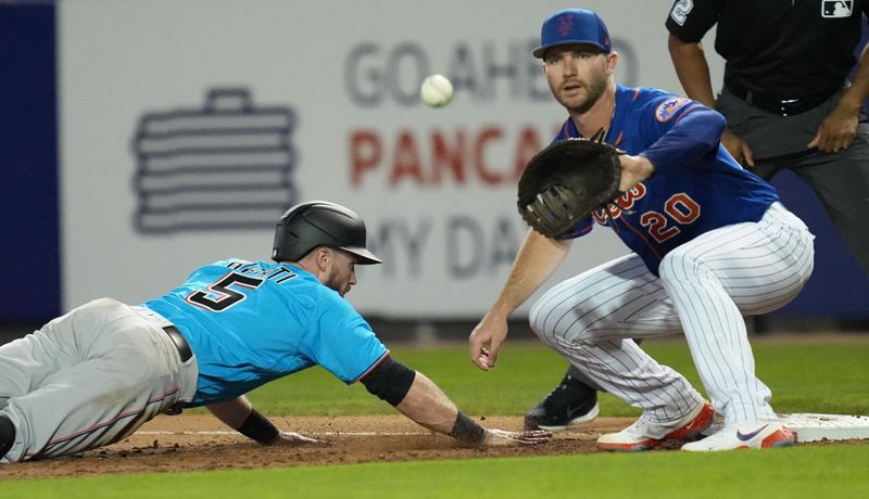 Feb 25, 2023; Port St. Lucie, Florida, USA;  Miami Marlins second baseman Jon Berti (5) dives back into first base as New York Mets first baseman Pete Alonso (20) covers on the play in the third inning at Clover Park. Mandatory Credit: Jim Rassol-USA TODAY Sports