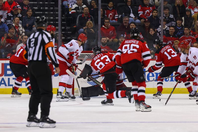 Nov 21, 2024; Newark, New Jersey, USA; New Jersey Devils left wing Jesper Bratt (63) scores a goal against the Carolina Hurricanes during the third period at Prudential Center. Mandatory Credit: Ed Mulholland-Imagn Images