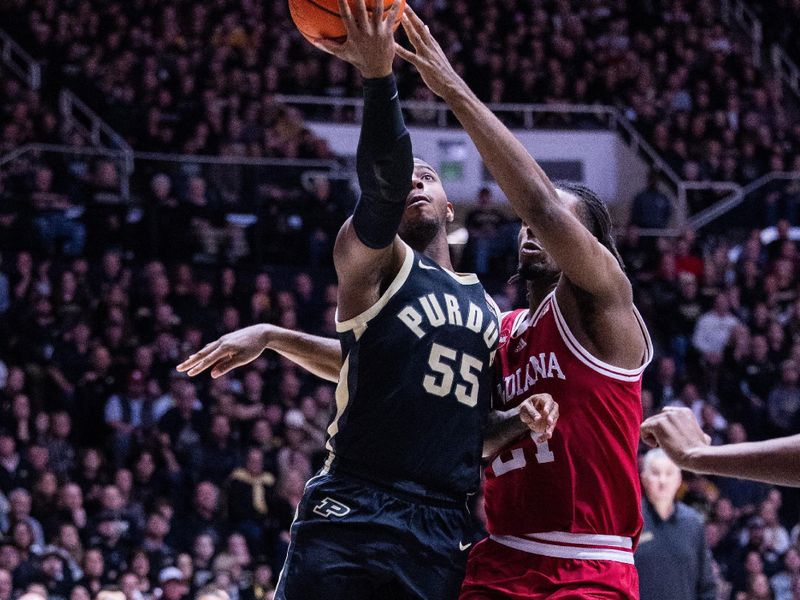 Feb 10, 2024; West Lafayette, Indiana, USA; Purdue Boilermakers guard Lance Jones (55) shoots the ball while Indiana Hoosiers forward Mackenzie Mgbako (21) defends in the second half at Mackey Arena. Mandatory Credit: Trevor Ruszkowski-USA TODAY Sports