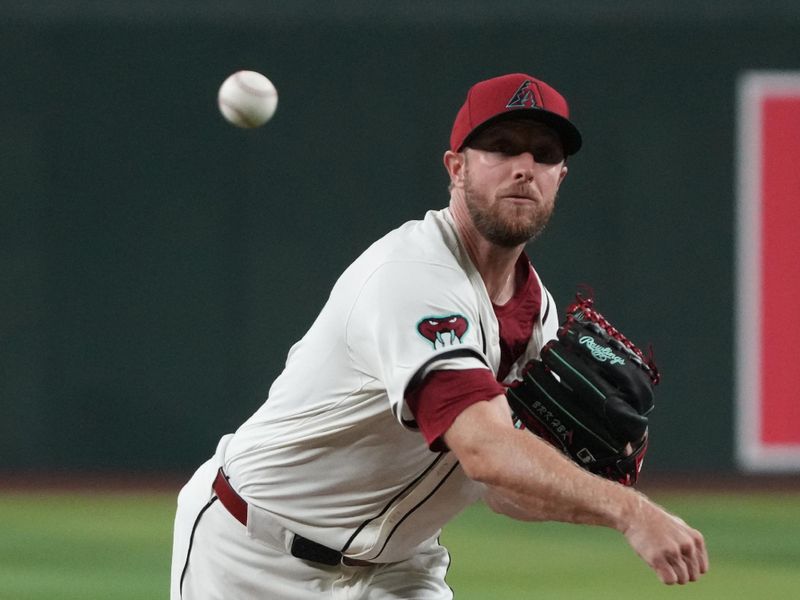 Aug 11, 2024; Phoenix, Arizona, USA; Arizona Diamondbacks pitcher Merrill Kelly (29) throws against the Philadelphia Phillies in the first inning at Chase Field. Mandatory Credit: Rick Scuteri-USA TODAY Sports