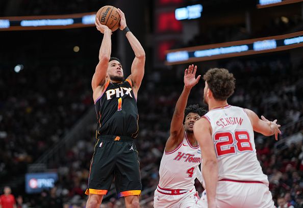 HOUSTON, TEXAS - DECEMBER 27: Devin Booker #1 of the Phoenix Suns goes up for a shot during the second quarter of the game against the Houston Rockets at Toyota Center on December 27, 2023 in Houston, Texas. User expressly acknowledges and agrees that, by downloading and or using this photograph, User is consenting to the terms and conditions of the Getty Images License Agreement. (Photo by Alex Bierens de Haan/Getty Images)