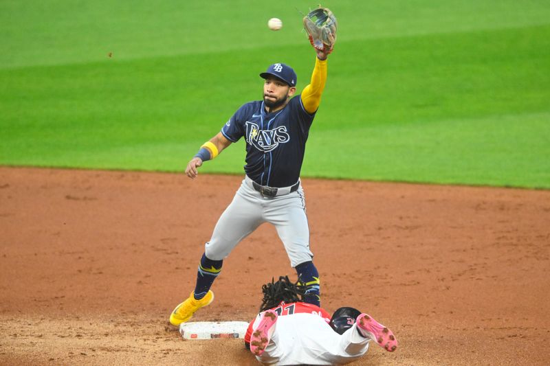 Sep 12, 2024; Cleveland, Ohio, USA; Cleveland Guardians designated hitter Jose Ramirez (11) steals second base beside Tampa Bay Rays shortstop Jose Caballero (7) in the first inning at Progressive Field. Mandatory Credit: David Richard-Imagn Images