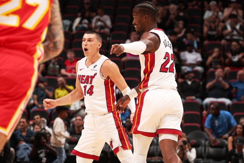 MIAMI, FL - OCTOBER 16: Jimmy Butler #22 and Tyler Herro #14 of the Miami Heat look on during the game against the Atlanta Hawks on October 16, 2024 at Miami-Dade Arena in Miami, Florida. NOTE TO USER: User expressly acknowledges and agrees that, by downloading and or using this Photograph, user is consenting to the terms and conditions of the Getty Images License Agreement. Mandatory Copyright Notice: Copyright 2024 NBAE (Photo by Issac Baldizon/NBAE via Getty Images)