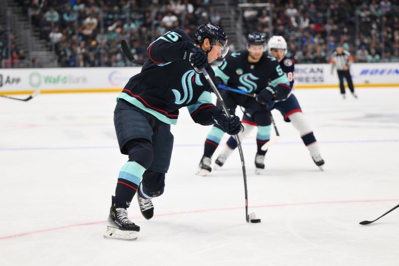 Nov 12, 2024; Seattle, Washington, USA; Seattle Kraken left wing Andre Burakovsky (95) shoots the puck against the Columbus Blue Jackets during the third period at Climate Pledge Arena. Mandatory Credit: Steven Bisig-Imagn Images