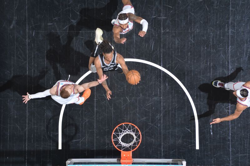 SAN ANTONIO, TX - MARCH 29: Devin Vassell #24 of the San Antonio Spurs drives to the basket during the game against the New York Knicks on March 29, 2024 at the Frost Bank Center in San Antonio, Texas. NOTE TO USER: User expressly acknowledges and agrees that, by downloading and or using this photograph, user is consenting to the terms and conditions of the Getty Images License Agreement. Mandatory Copyright Notice: Copyright 2024 NBAE (Photos by Michael Gonzales/NBAE via Getty Images)