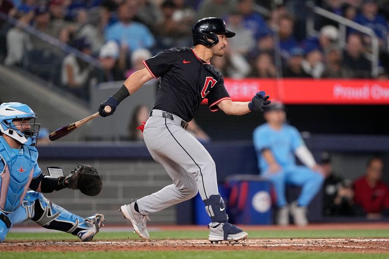 May 4, 2025; Toronto, Ontario, CAN; Cleveland Guardians left fielder Steven Kwan (38) hits a single against the Toronto Blue Jays during the fifth inning at Rogers Centre. Mandatory Credit: John E. Sokolowski-Imagn Images