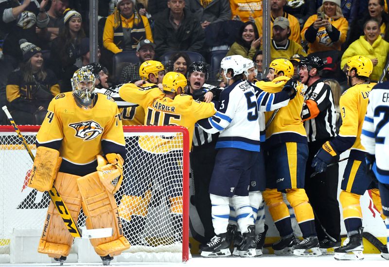 Nov 26, 2023; Nashville, Tennessee, USA; Nashville Predators and Winnipeg Jets players fight during the third period at Bridgestone Arena. Mandatory Credit: Christopher Hanewinckel-USA TODAY Sports