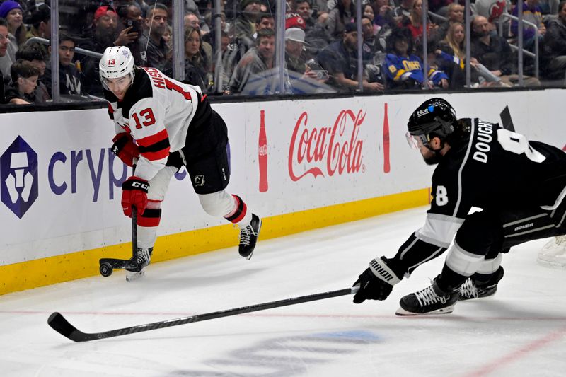 Mar 3, 2024; Los Angeles, California, USA;  Los Angeles Kings defenseman Drew Doughty (8) defends a pass by New Jersey Devils center Nico Hischier (13) in the first period at Crypto.com Arena. Mandatory Credit: Jayne Kamin-Oncea-USA TODAY Sports