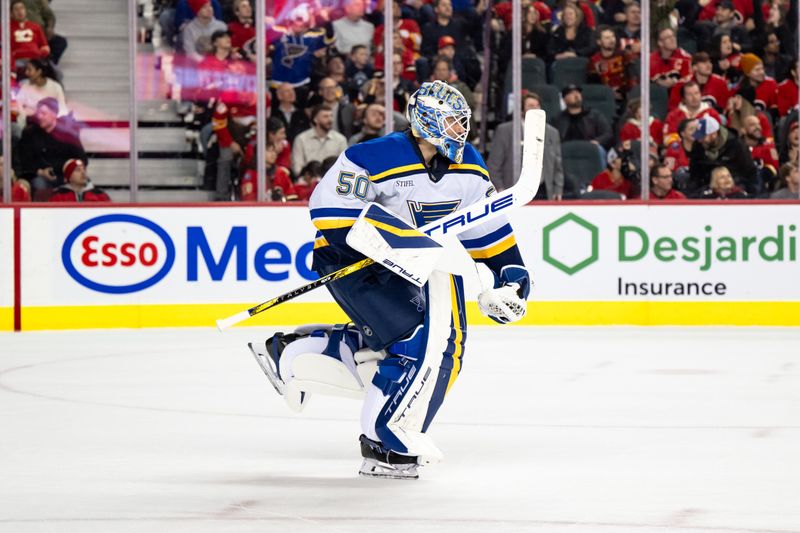 Dec 5, 2024; Calgary, Alberta, CAN; St. Louis Blues goaltender Jordan Binnington (50) celebrates after his team’s 4-3 win in overtime against the Calgary Flames at Scotiabank Saddledome. Mandatory Credit: Brett Holmes-Imagn Images