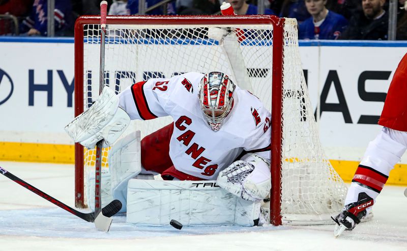 Jan 2, 2024; New York, New York, USA; Carolina Hurricanes goalie Pyotr Kochetkov (52) makes a save against the New York Rangers during the first period at Madison Square Garden. Mandatory Credit: Danny Wild-USA TODAY Sports