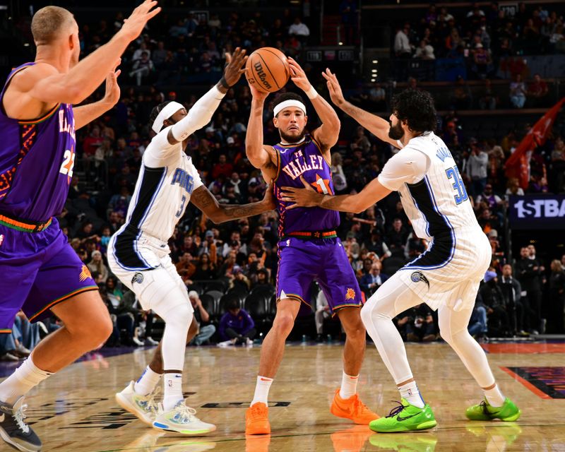 PHOENIX, AZ - NOVEMBER 18: Devin Booker #1 of the Phoenix Suns looks to pass the ball during the game against the Orlando Magic on November 18, 2024 at Footprint Center in Phoenix, Arizona. NOTE TO USER: User expressly acknowledges and agrees that, by downloading and or using this photograph, user is consenting to the terms and conditions of the Getty Images License Agreement. Mandatory Copyright Notice: Copyright 2024 NBAE (Photo by Kate Frese/NBAE via Getty Images)