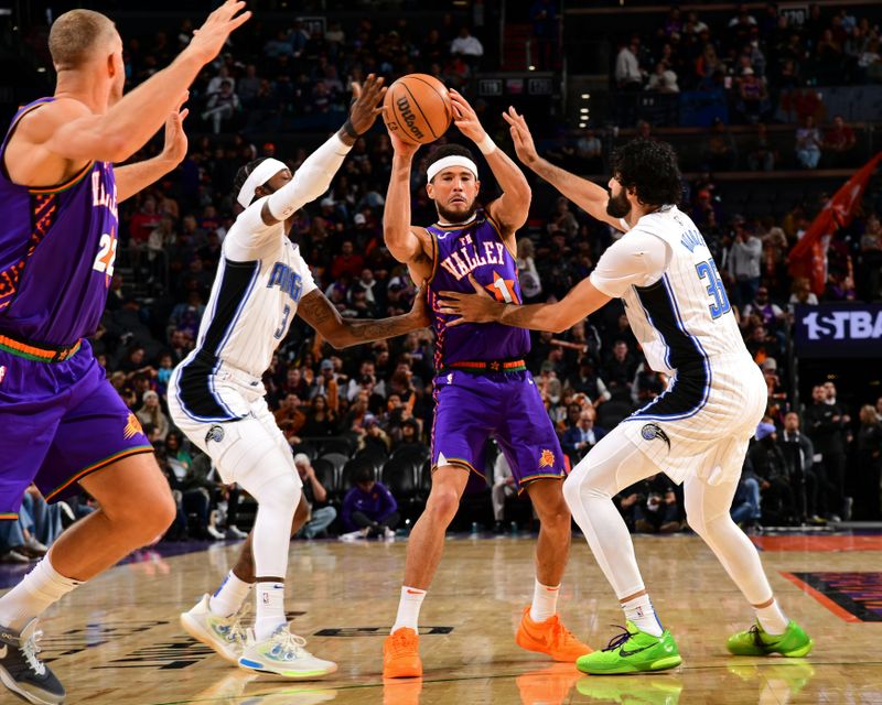 PHOENIX, AZ - NOVEMBER 18: Devin Booker #1 of the Phoenix Suns looks to pass the ball during the game against the Orlando Magic on November 18, 2024 at Footprint Center in Phoenix, Arizona. NOTE TO USER: User expressly acknowledges and agrees that, by downloading and or using this photograph, user is consenting to the terms and conditions of the Getty Images License Agreement. Mandatory Copyright Notice: Copyright 2024 NBAE (Photo by Kate Frese/NBAE via Getty Images)