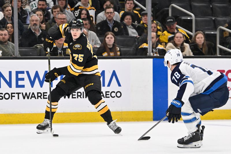 Mar 19, 2026; Boston, Massachusetts, USA; Boston Bruins forward Lukas Reichel (75) controls the puck against the Winnipeg Jets defenseman Jacob Bryson (78) during the third period at TD Garden. Mandatory Credit: Eric Canha-Imagn Images