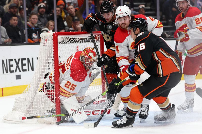 Dec 21, 2023; Anaheim, California, USA;  Calgary Flames goaltender Jacob Markstrom (25) defends the goal against Anaheim Ducks center Ryan Strome (16) and right wing Frank Vatrano (77) during the second period at Honda Center. Mandatory Credit: Kiyoshi Mio-USA TODAY Sports