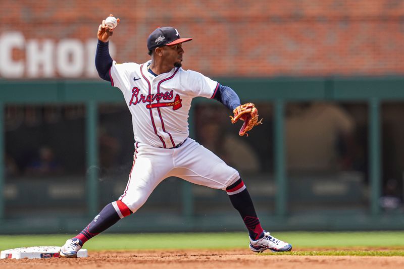 May 15, 2025; Cumberland, Georgia, USA; Atlanta Braves second base Ozzie Albies (1) throws for a double play against the Washington Nationals during the second inning at Truist Park. Mandatory Credit: Dale Zanine-Imagn Images