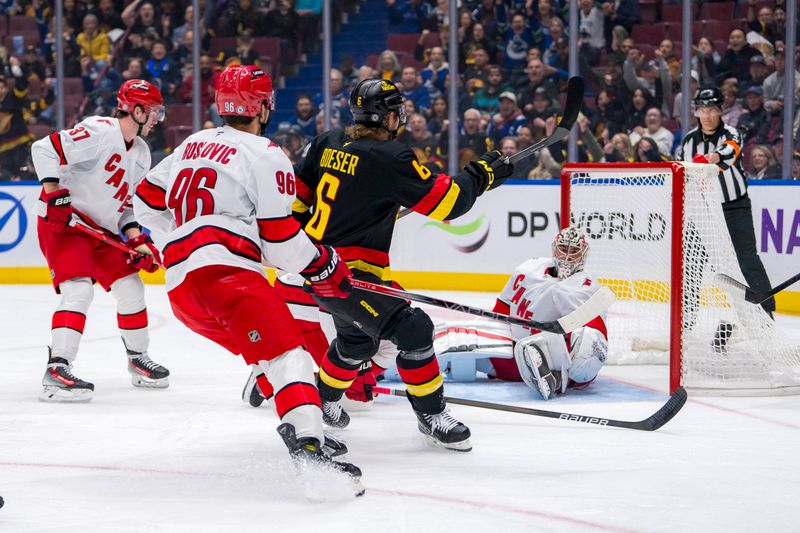 Oct 28, 2024; Vancouver, British Columbia, CAN; Vancouver Canucks forward Brock Boeser (6) scores on Carolina Hurricanes goalie Pyotr Kochetkov (52) as forward Andrei Svechnikov (37) and forward Jack Roslovic (96) watch during the first period at Rogers Arena. Mandatory Credit: Bob Frid-Imagn Images