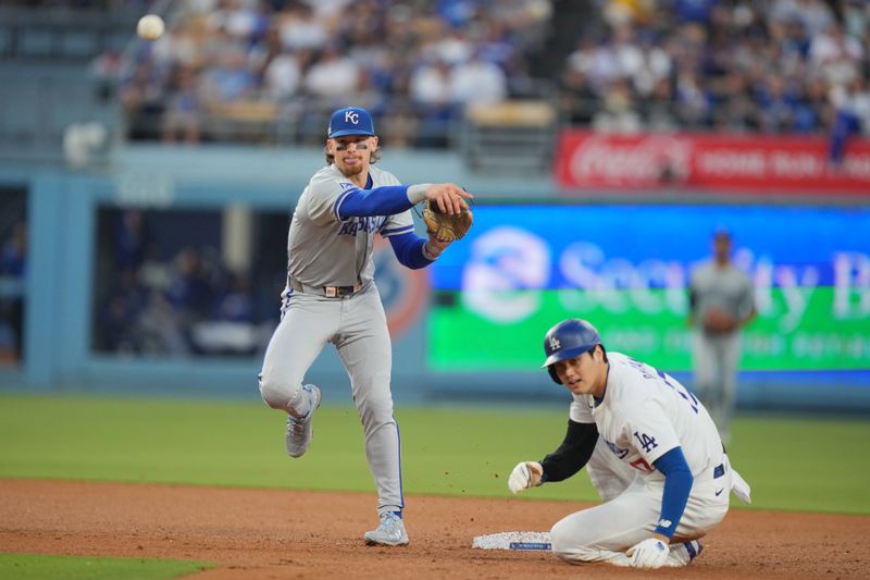 Jun 14, 2024; Los Angeles, California, USA; Kansas City Royals shortstop Bobby Witt Jr. (7) forces out Los Angeles Dodgers designated hitter Shohei Ohtani (17) at second base in the third inning at Dodger Stadium. Mandatory Credit: Kirby Lee-USA TODAY Sports