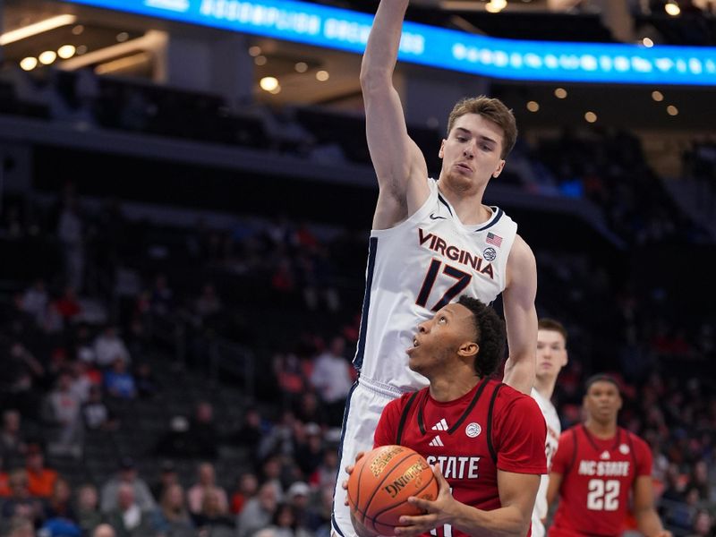 Mar 12, 2026; Charlotte, NC, USA; Virginia Cavaliers center Johann Grünloh (17) defends against NC State Wolfpack guard Quadir Copeland (11) at the basket during the second half at Spectrum Center. Mandatory Credit: Jim Dedmon-Imagn Images Mar 12, 2026; Charlotte, NC, USA; Virginia Cavaliers center Johann Grünloh (17) defends against NC State Wolfpack guard Quadir Copeland (11) at the basket during the second half at Spectrum Center. Mandatory Credit: Jim Dedmon-Imagn Images