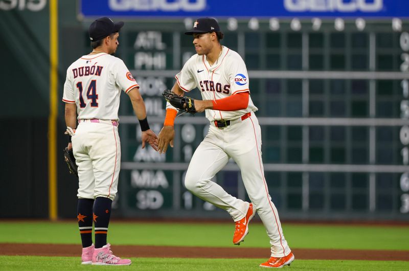 May 27, 2025; Houston, Texas, USA; Houston Astros right fielder Cam Smith (11) celebrates with second baseman Mauricio Dubon (14) after defeating the Athletics at Daikin Park. Mandatory Credit: Thomas Shea-Imagn Images