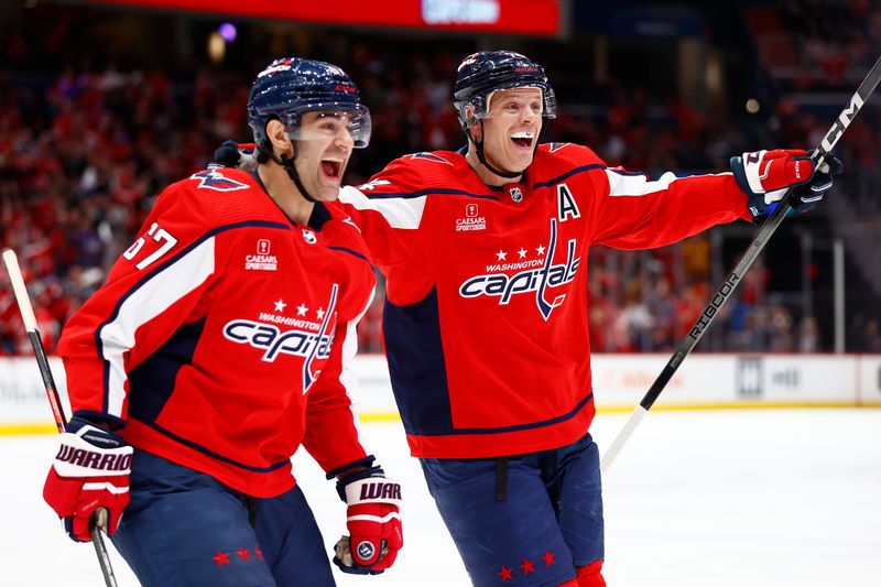 Mar 26, 2024; Washington, District of Columbia, USA; Washington Capitals defenseman John Carlson (74) and Capitals left wing Max Pacioretty (67) celebrates after a goal by Capitals center Dylan Strome (not pictured) during the third period against the Detroit Red Wings at Capital One Arena. Mandatory Credit: Amber Searls-USA TODAY Sports