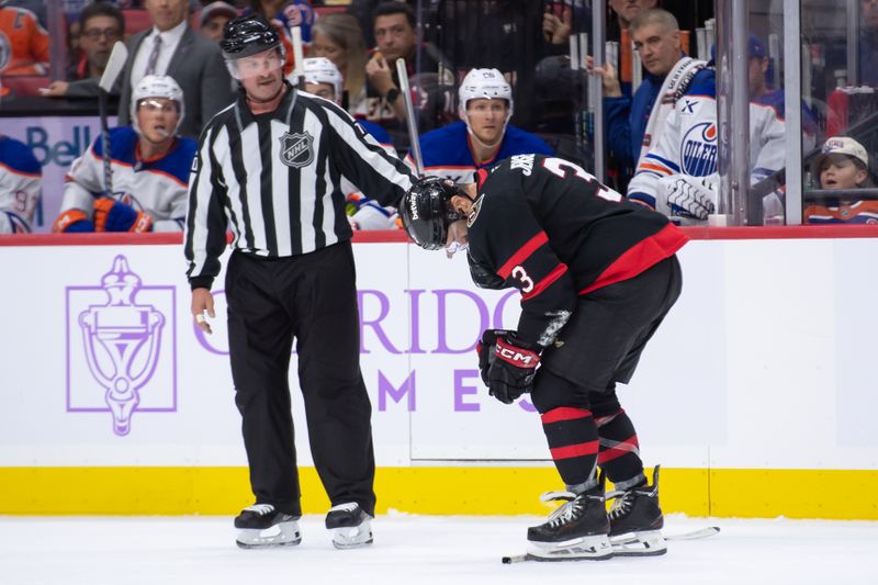 Nov 19, 2024; Ottawa, Ontario, CAN; Ottawa Senators defenseman Nick Jensen (3) is helped off the ice after making contact with the curved glass in the second period against the  Edmonton Oilers at the Canadian Tire Centre. Mandatory Credit: Marc DesRosiers-Imagn Images