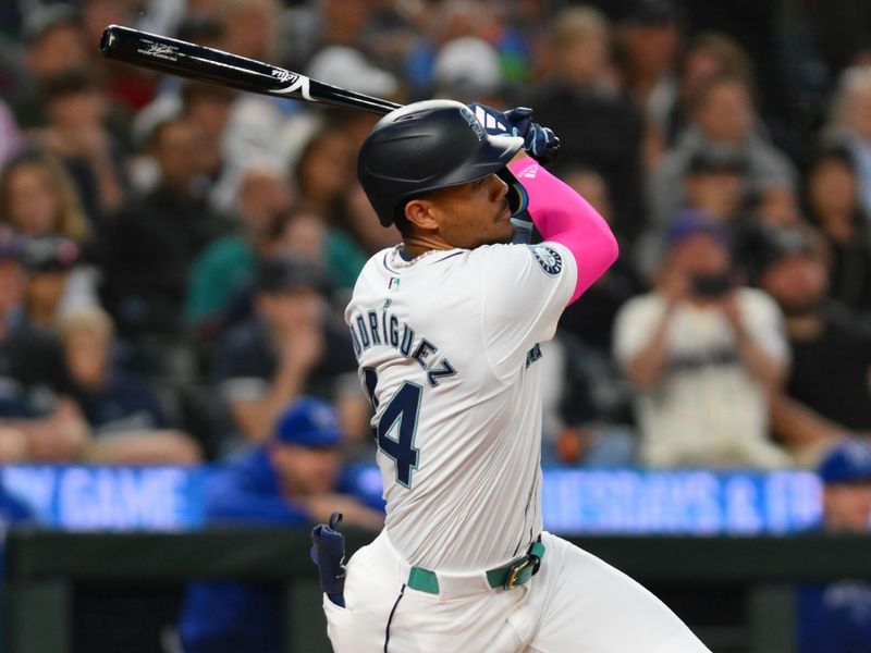 May 14, 2024; Seattle, Washington, USA; Seattle Mariners center fielder Julio Rodriguez (44) hits a single against the Kansas City Royals during the eighth inning at T-Mobile Park. Mandatory Credit: Steven Bisig-USA TODAY Sports