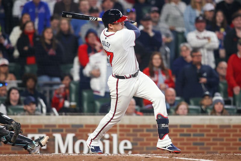 Apr 6, 2024; Atlanta, Georgia, USA; Atlanta Braves third baseman Austin Riley (27) hits a RBI single against the Arizona Diamondbacks in the eighth inning at Truist Park. Mandatory Credit: Brett Davis-USA TODAY Sports
