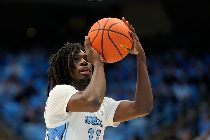 Jan 15, 2025; Chapel Hill, North Carolina, USA;  North Carolina Tar Heels guard Ian Jackson (11) shoot a free throw in the second half at Dean E. Smith Center. Mandatory Credit: Bob Donnan-Imagn Images