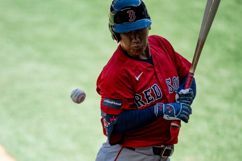 Mar 26, 2024; Arlington, Texas, USA; Boston Red Sox designated hitter Masataka Yoshida (7) is hit by a pitch during the sixth inning against the Texas Rangers at Globe Life Field. Mandatory Credit: Jerome Miron-USA TODAY Sports