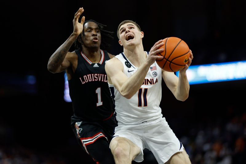 Mar 4, 2023; Charlottesville, Virginia, USA; Virginia Cavaliers guard Isaac McKneely (11) drives to the basket s Louisville Cardinals guard Mike James (1) defends in the second half at John Paul Jones Arena. Mandatory Credit: Geoff Burke-USA TODAY Sports