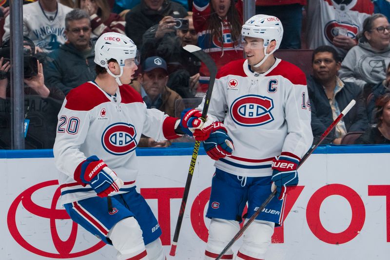 Mar 11, 2025; Vancouver, British Columbia, CAN; Montreal Canadiens forward Juraj Slafkovsky (20) and forward Nick Suzuki (14) celebrate Slafkovsky’s goal against the Vancouver Canucks  in the first period at Rogers Arena. Mandatory Credit: Bob Frid-Imagn Images