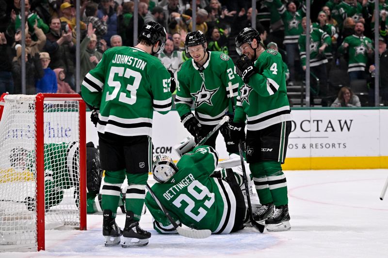 Jan 24, 2025; Dallas, Texas, USA; Dallas Stars center Wyatt Johnston (53) and center Roope Hintz (24) and defenseman Miro Heiskanen (4) stand over goaltender Jake Oettinger (29) after he makes a glove save against the Vegas Golden Knights to end the game at the American Airlines Center. Mandatory Credit: Jerome Miron-Imagn Images