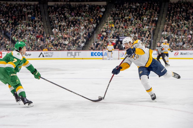 Dec 31, 2024; Saint Paul, Minnesota, USA; Nashville Predators left wing Filip Forsberg (9) shoots defended by Minnesota Wild defenseman Brock Faber (7) in the first period at Xcel Energy Center. Mandatory Credit: Matt Blewett-Imagn Images