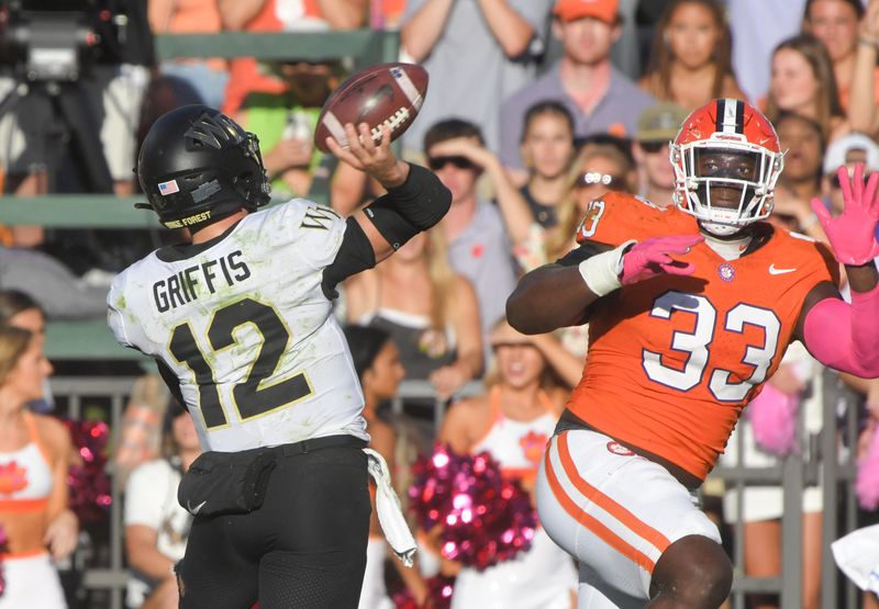 Oct 7, 2023; Clemson, South Carolina, USA; Clemson Tigers defensive tackle Ruke Orhorhoro (33) pressures Wake Forest Demon Deacons quarterback Mitch Griffis (12) during the third quarter at Memorial Stadium. Mandatory Credit: Ken Ruinard-USA TODAY Sports