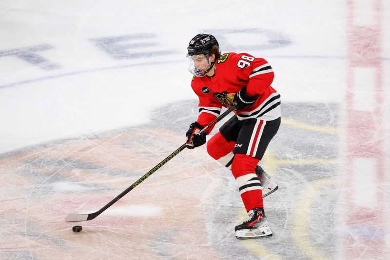 Mar 10, 2024; Chicago, Illinois, USA; Chicago Blackhawks center Connor Bedard (98) controls the puck against the Arizona Coyotes during the first period at United Center. Mandatory Credit: Kamil Krzaczynski-USA TODAY Sports