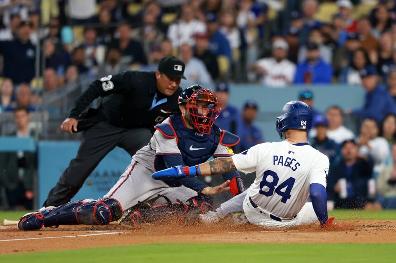 May 3, 2024; Los Angeles, California, USA;  Los Angeles Dodgers outfielder Andy Pages (84) is tagged out by Atlanta Braves catcher Travis d'Arnaud (16) in the second inning at Dodger Stadium. Mandatory Credit: Kiyoshi Mio-USA TODAY Sports