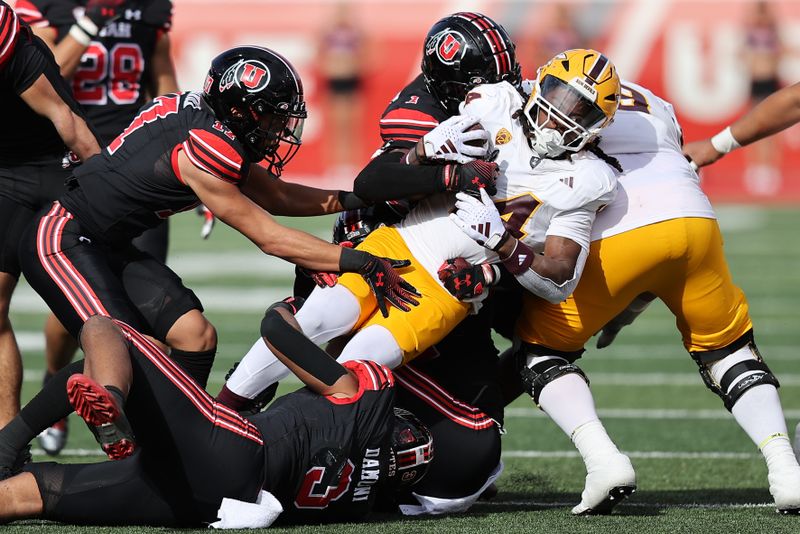 Nov 4, 2023; Salt Lake City, Utah, USA; Arizona State Sun Devils running back Kyson Brown (14) is tackled by Utah Utes cornerback Miles Battle (1) and linebacker Levani Damuni (3) and cornerback Smith Snowden (17) in the third quarter at Rice-Eccles Stadium. Mandatory Credit: Rob Gray-USA TODAY Sports