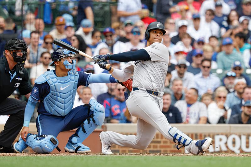 Sep 6, 2024; Chicago, Illinois, USA; New York Yankees outfielder Juan Soto (22) singles against the Chicago Cubs during the third inning at Wrigley Field. Mandatory Credit: Kamil Krzaczynski-Imagn Images