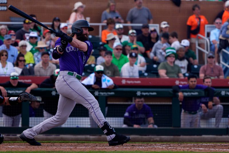 Mar 17, 2024; Scottsdale, Arizona, USA; Colorado Rockies designated hitter Charlie Blackmon (19) singles on a line drive to right in the top of the fifth during a spring training game against the San Francisco Giants at Scottsdale Stadium. Mandatory Credit: Allan Henry-USA TODAY Sports