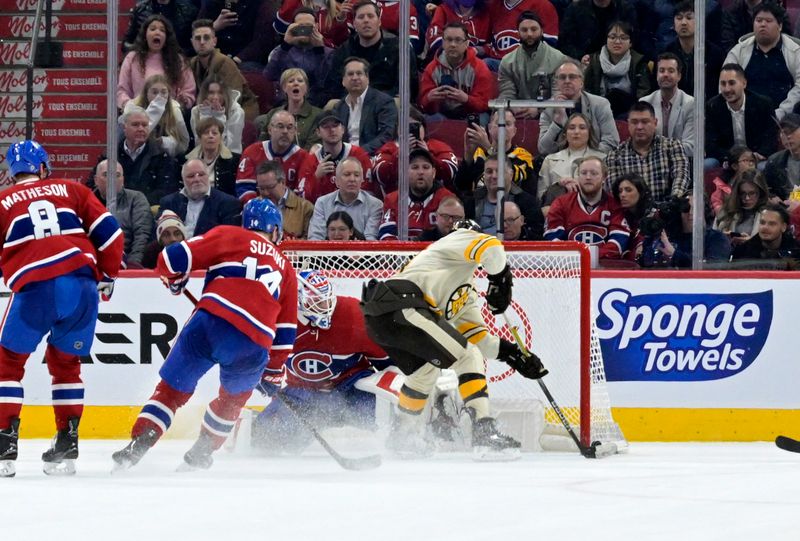 Mar 14, 2024; Montreal, Quebec, CAN; Boston Bruins forward Jake DeBrusk (74) scores the winning goal against Montreal Canadiens goalie Sam Montembeault (35) during the overtime period at the Bell Centre. Mandatory Credit: Eric Bolte-USA TODAY Sports